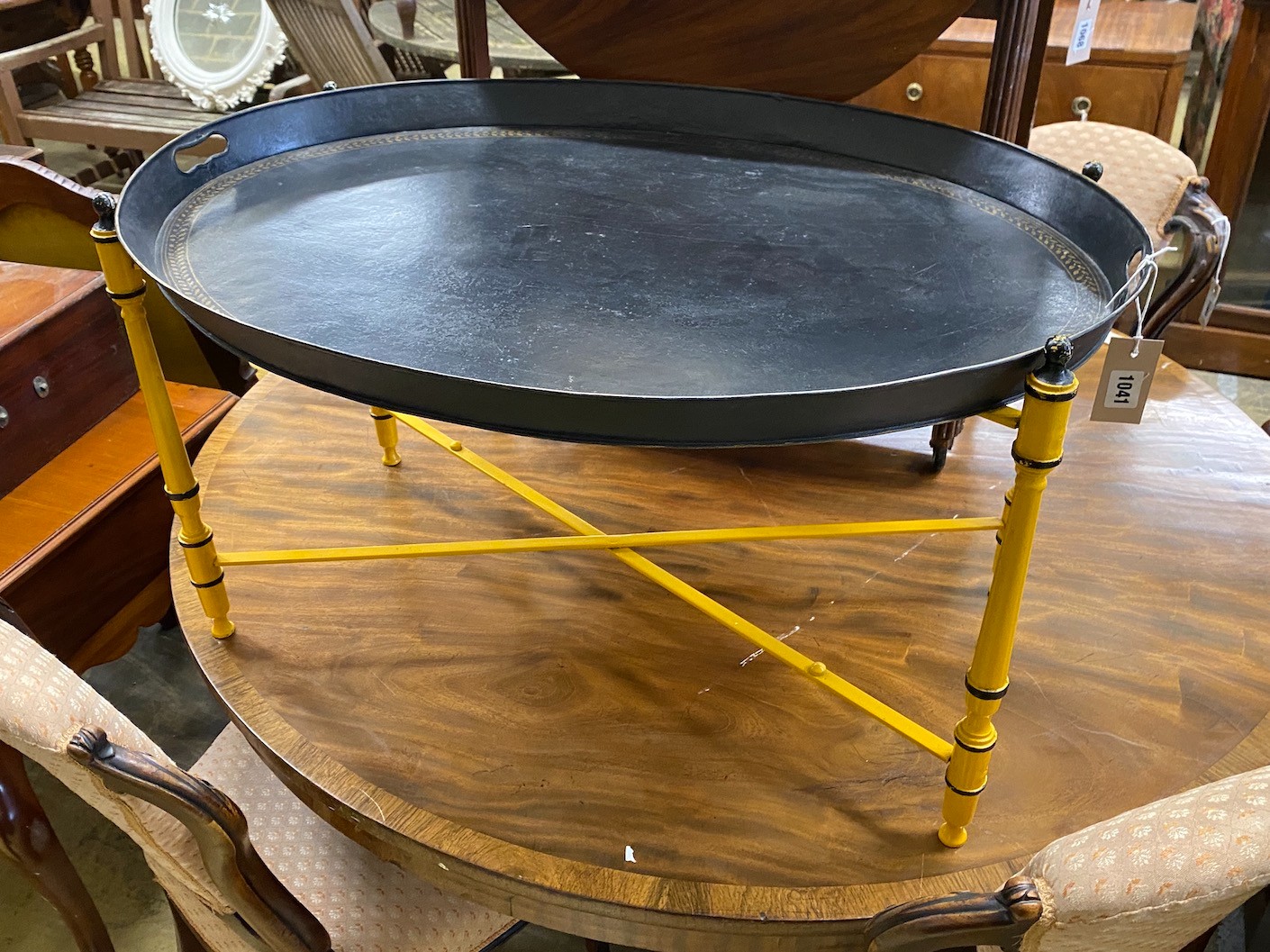 An oval Regency style toleware tray top table on folding stand, width 80cm, depth 61cm, height 43cm